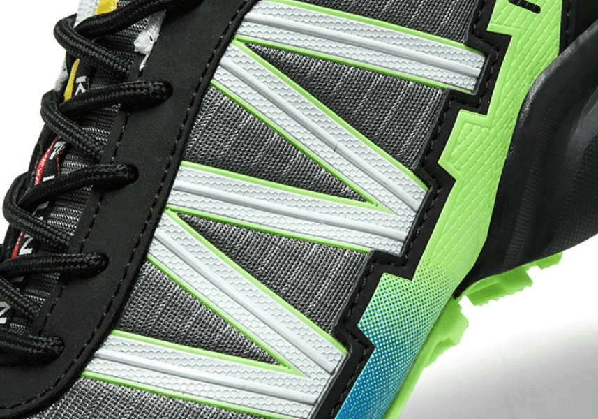 Close-up of waterproof non-slip men's sneaker with geometric design and lace-up closure, featuring breathable, lightweight materials.